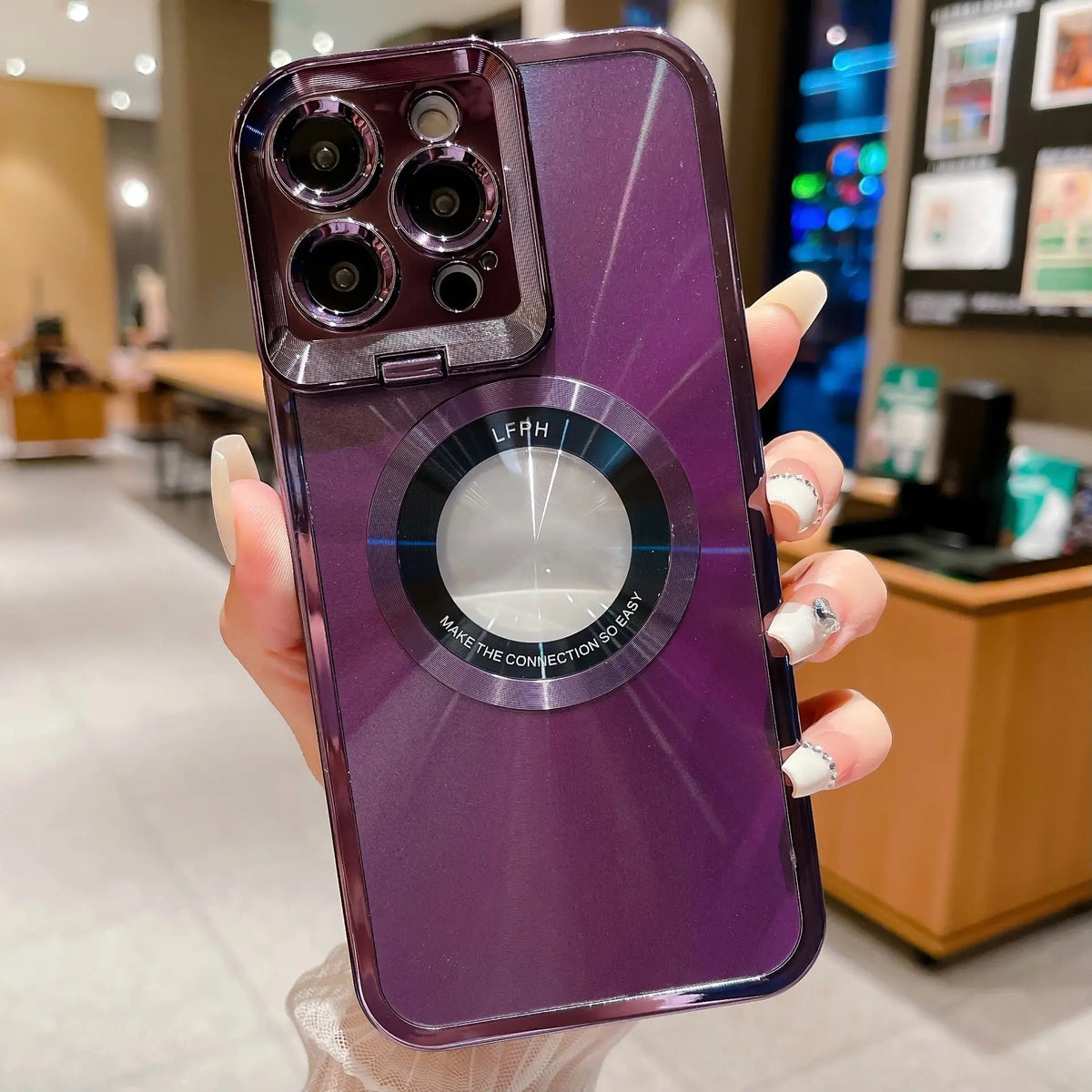 Close-up of purple electroplated iPhone case with CD pattern, magnetic ring, and large camera protection for Pro Max models