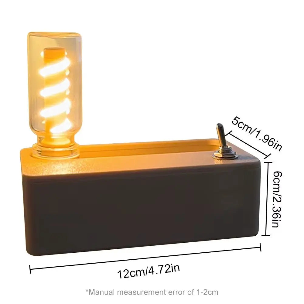 Compact mechanical flip night light with warm LED bulb and metal toggle switch on black rectangular base