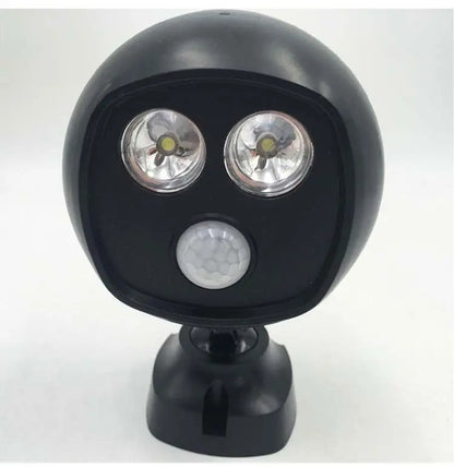 Black round LED sports light with dual bulbs and sensor on an adjustable mount against a white background