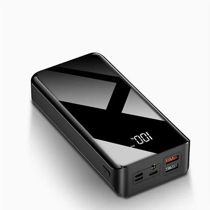 3D angled view of sleek black 30000mAh power bank with digital display and multiple charging ports visible