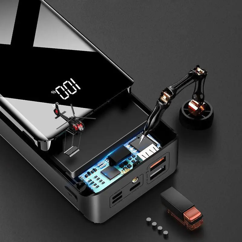 Top view of sleek black 30000mAh power bank with digital display and miniature tools on dark background