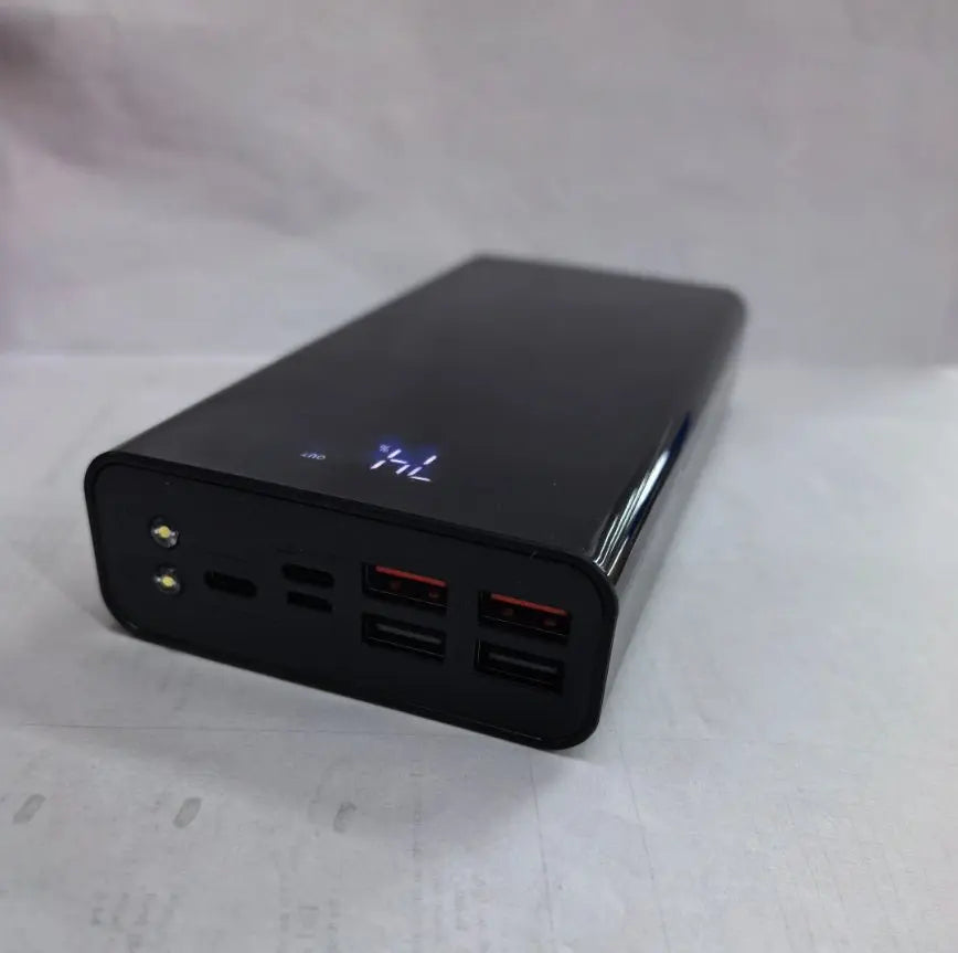 Black 30000mAh power bank with digital display, two LED lights, and multiple USB charging ports on front panel