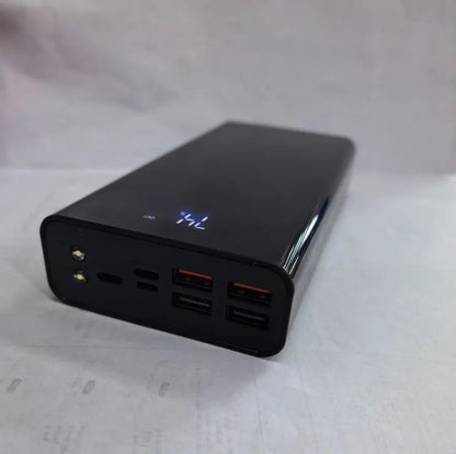 Black 30000mAh power bank with digital display, two LED lights, and multiple USB charging ports on front panel