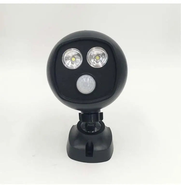 Compact black LED sports security light with dual floodlights and motion sensor on adjustable mount against white background