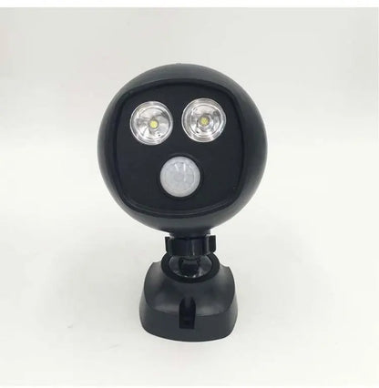 Compact black LED sports security light with dual floodlights and motion sensor on adjustable mount against white background
