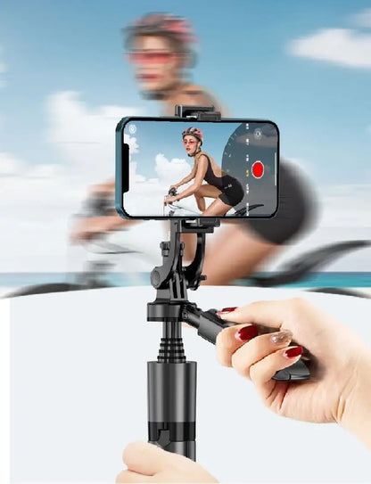 Smartphone mounted on 360° auto face tracking gimbal held by hand capturing cyclist with blurred action background