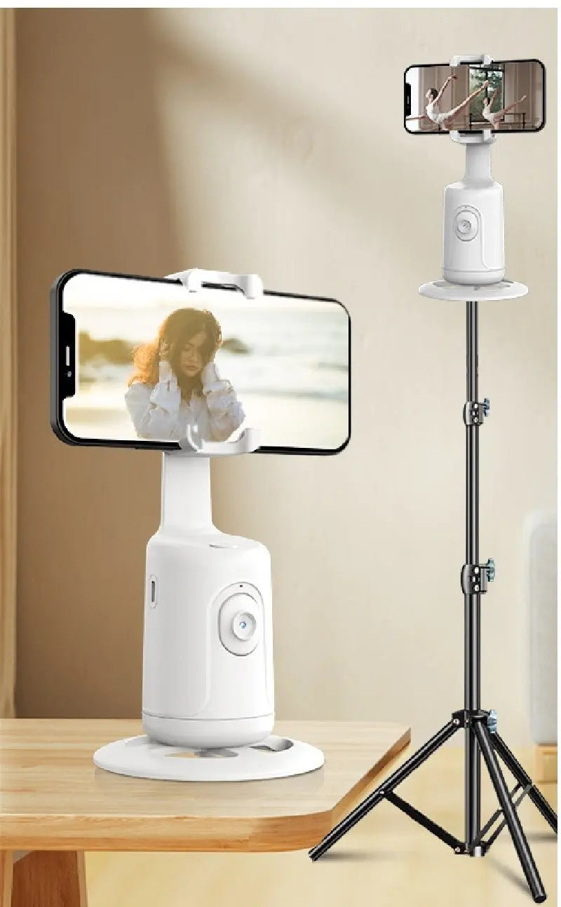 White 360 auto face tracking gimbal phone holder shown on table and extended tripod stand with smartphone mounted