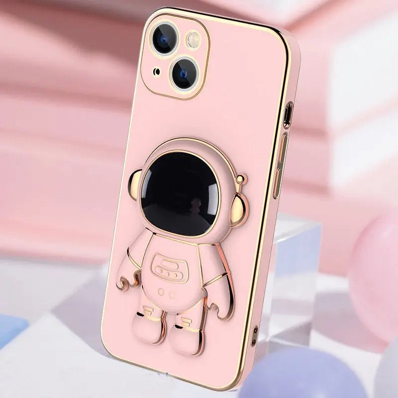 Pink iPhone case with raised 3D cartoon astronaut design and gold electroplated edges and bracket detail