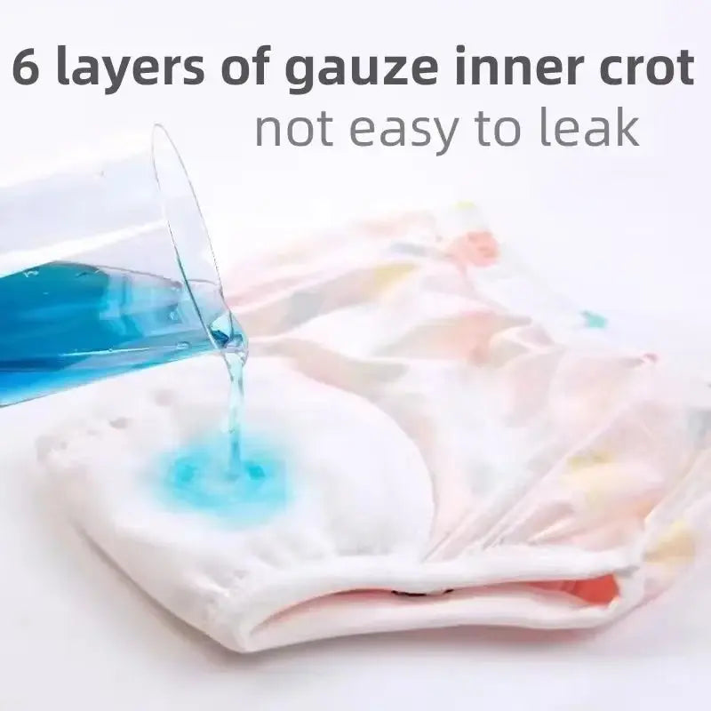 Close-up of white baby waterproof training pants showing six layers of gauze inner crotch with liquid poured on top