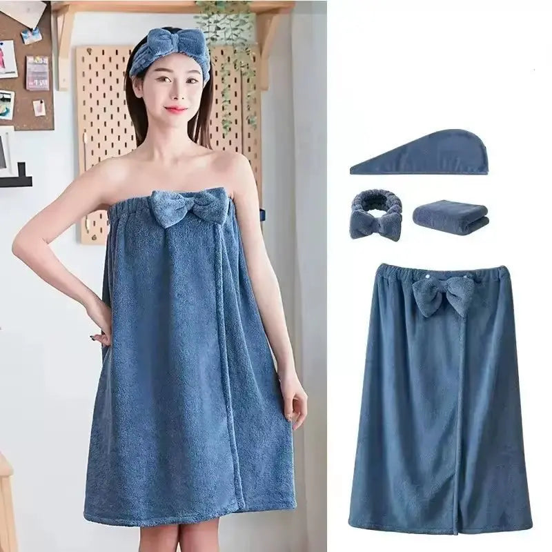 Woman wearing blue microfiber bath towel dress with matching headband and hair wrap, with additional towel set pieces displayed