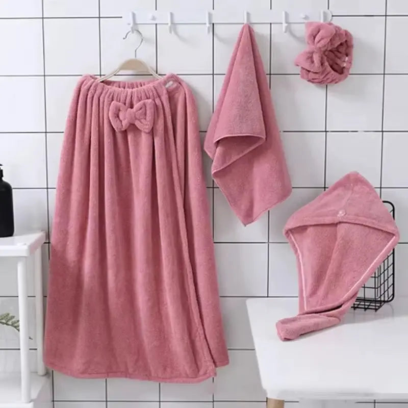 4-piece pink microfiber bath towel set for women including skirt, face towel, hair towel, and shower cap hanging on hooks