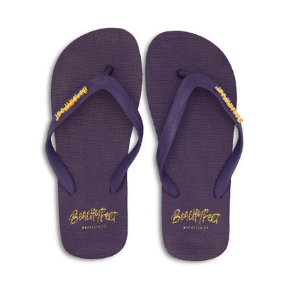 Pair of navy blue BeachyFeet® men's flip flops with textured sole and yellow logo on straps and footbed