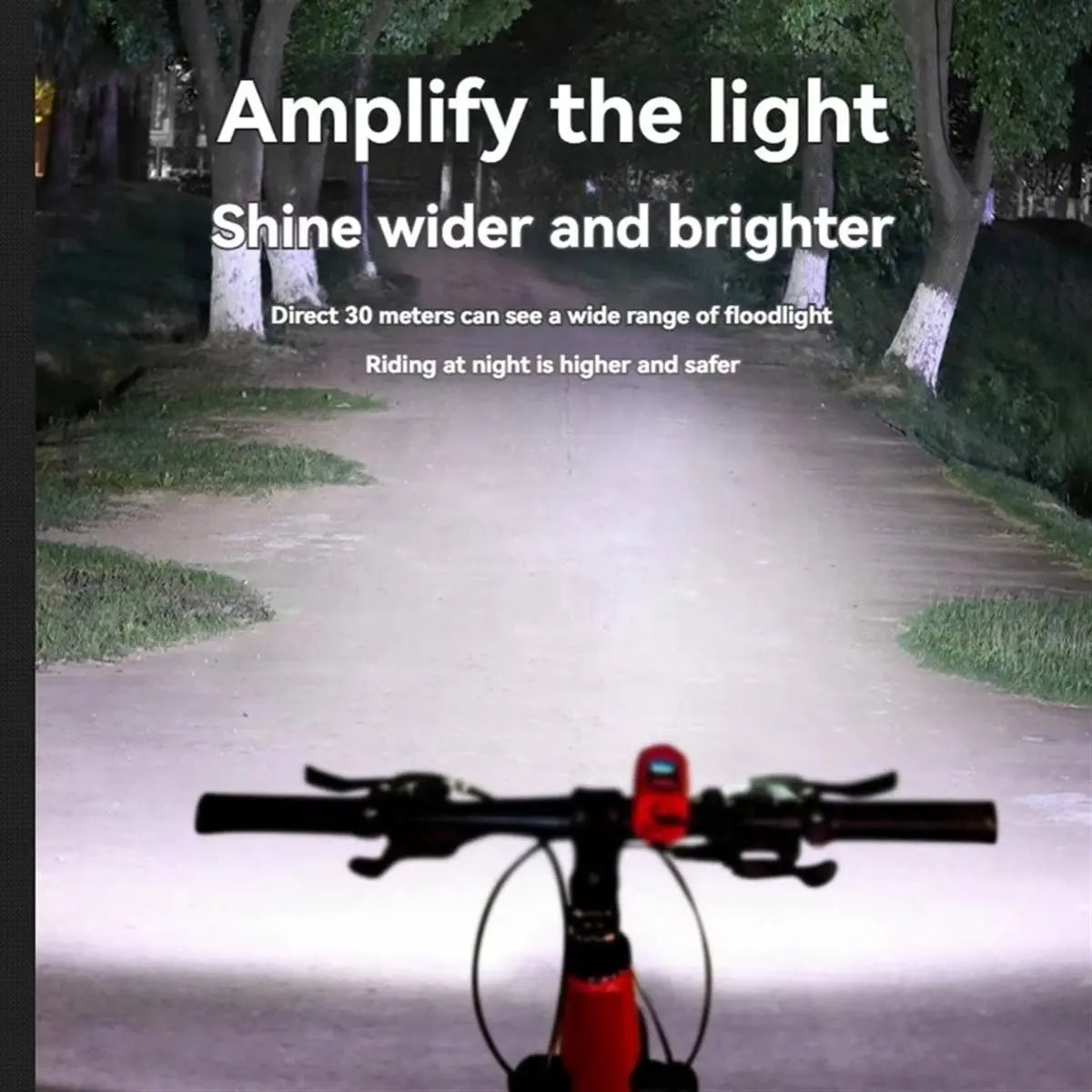 View from bike handlebar showing wide bright floodlight beam illuminating path and trees for safe night riding