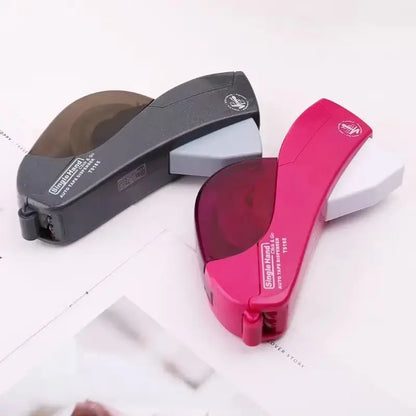 Two hand-held automatic tape dispensers in black and red with ergonomic design for easy cutting and gift wrapping use