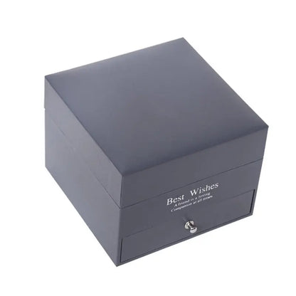 Dark grey square jewelry gift box with silver knob and "Best Wishes" text on front side