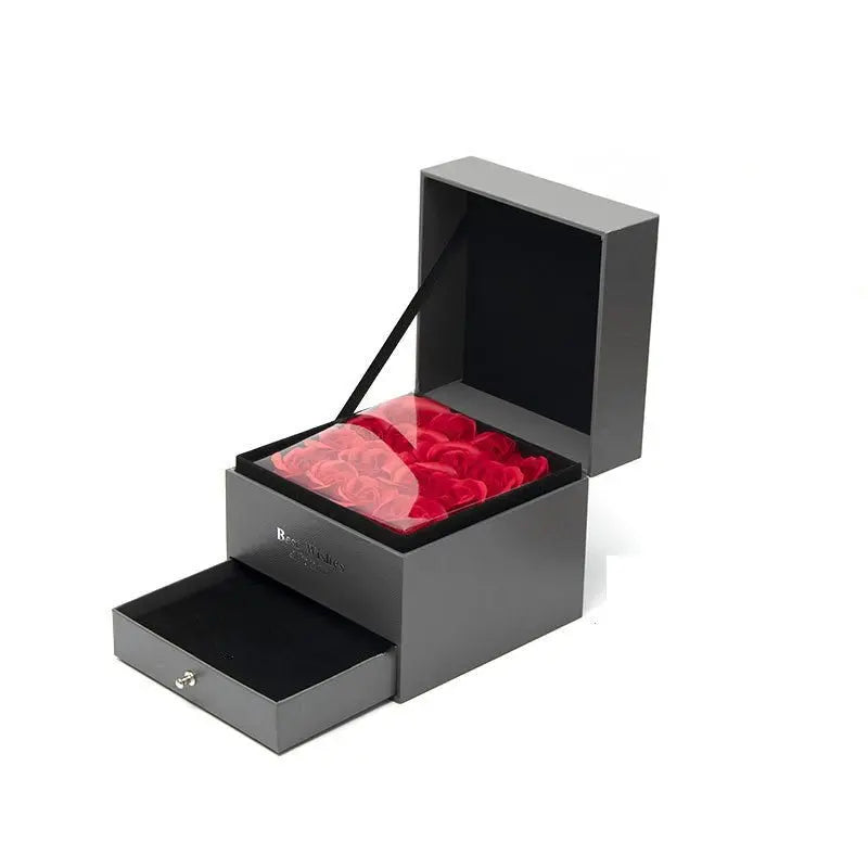 Black gift box with red preserved roses under clear lid and lower drawer, ideal Valentine's Day present packaging