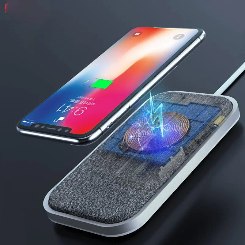 Wireless fast charger with fabric surface and glowing coil charging an Apple iPhone displaying battery level on screen