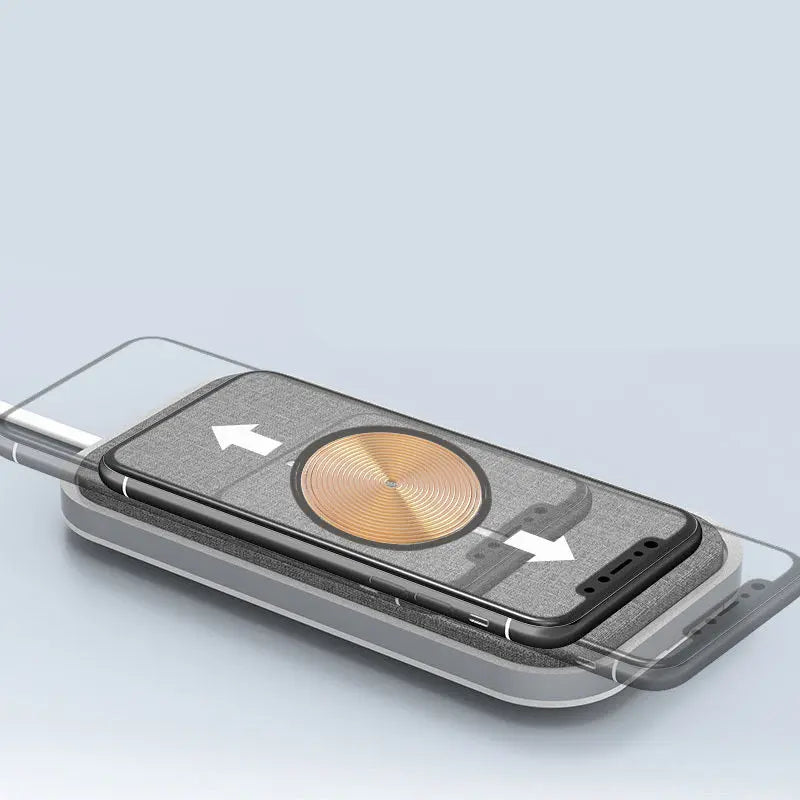 Close-up of universal wireless fast charger pad with smartphone demonstrating automatic alignment arrows on screen
