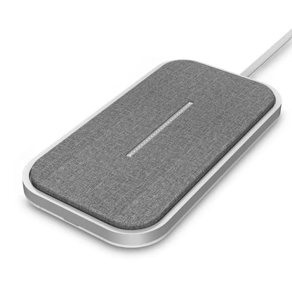 Grey fabric wireless charger pad with slim white frame and LED indicator strip connected by white charging cable