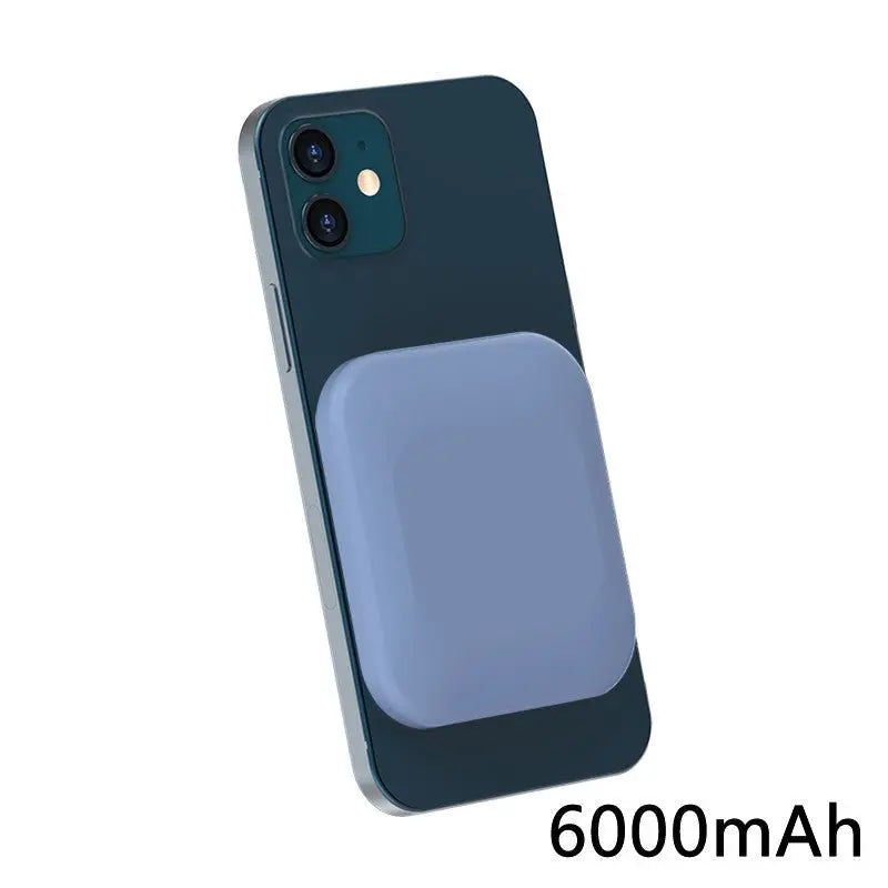 Light blue magnetic wireless power bank attached to the back of a dark blue iPhone with 6000mAh capacity visible