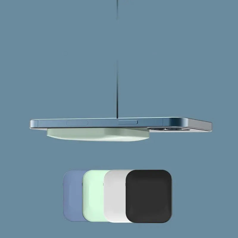Floating side view of wireless magnetic power bank charging an Apple iPhone with color options below on blue background