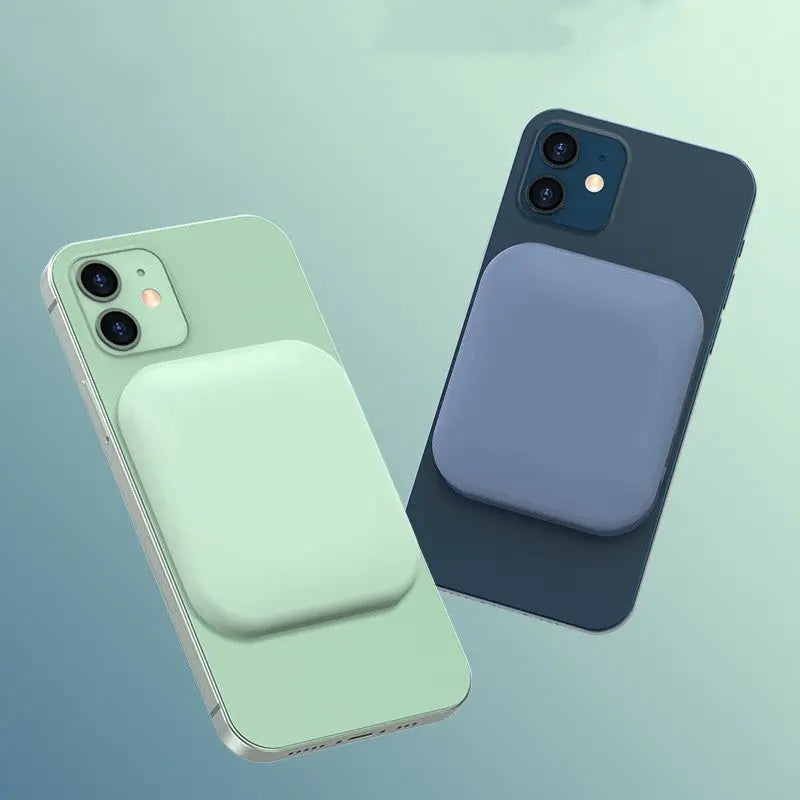 Two iPhones in green and blue with compatible MagSafe magnetic wireless charging power banks attached on the back