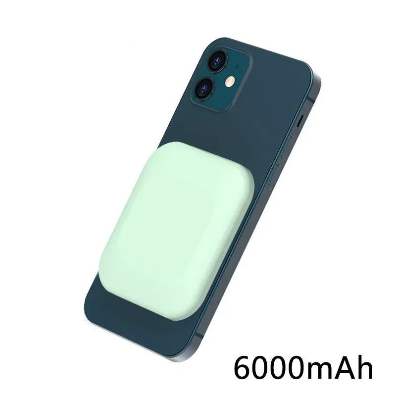 Compatible magnetic wireless charging power bank attached to dark blue iPhone with 6000mAh capacity shown