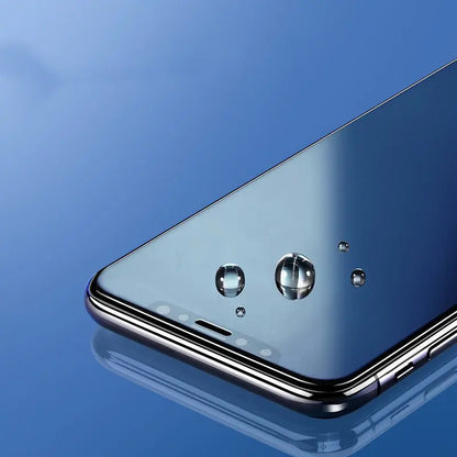 Close-up of Apple iPhone screen with privacy film showing water droplets on tempered glass surface against blue background