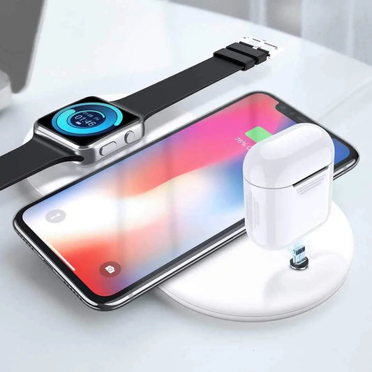 White wireless charger charging a smartphone, smartwatch, and wireless earbuds simultaneously on a round pad