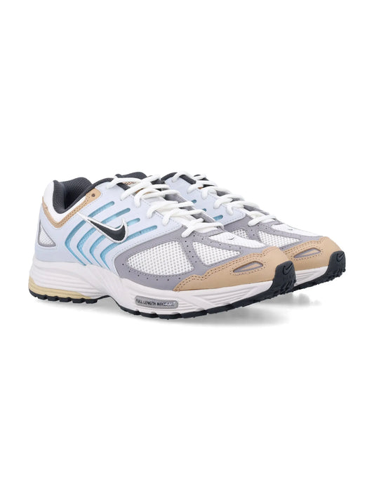 Men's white and beige Nike athletic running sneakers with black swoosh and breathable mesh upper in side view
