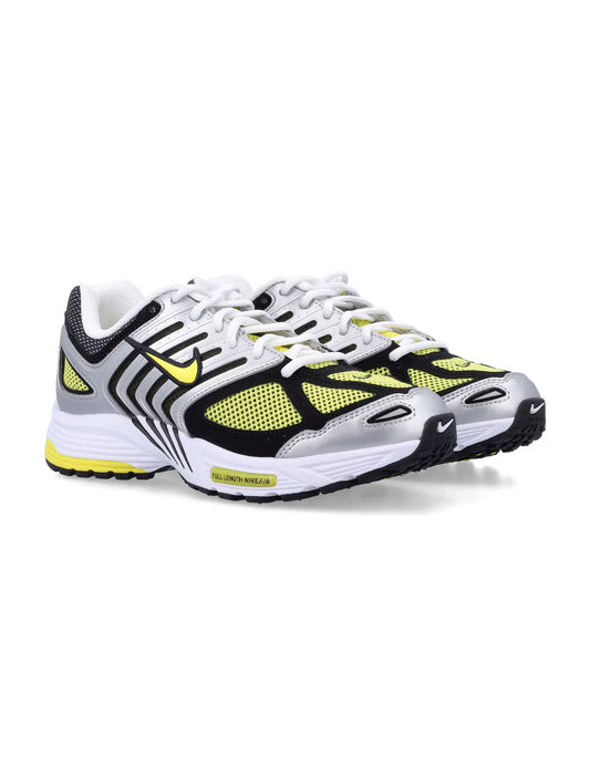 White, yellow, and black Nike women's sneakers with fabric and leather upper, round toe, and lacing closure