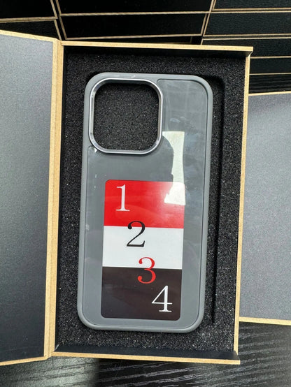 Gray E-ink phone case with numbered design in black foam-lined luxury packaging box opened flat