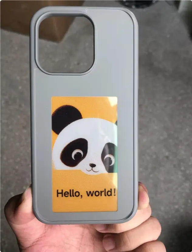 Grey E-ink screen phone case displaying a panda graphic and "Hello, world!" text on the screen panel