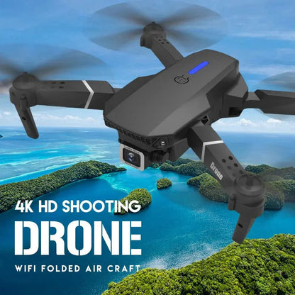 Black foldable E88 Pro quadcopter drone with 4K HD camera flying over tropical island and ocean background