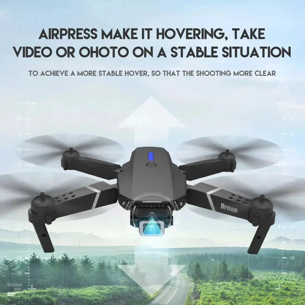 Black foldable quadcopter drone hovering with blue camera light and blurred rotors over forest and road background