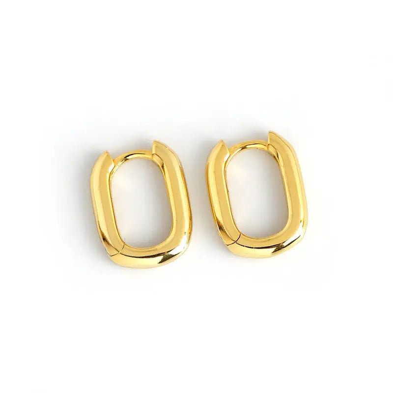Pair of gold-plated 925 sterling silver Korean style oval geometric hoop earrings on white background