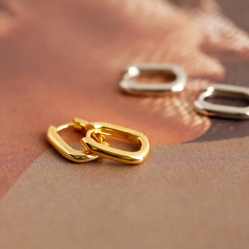 Close-up of gold-plated and silver Korean style geometric oval ring 925 sterling silver ear buckle earrings