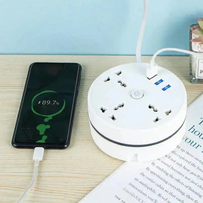 Round white EU plug smart power strip with USB ports charging a smartphone on wooden surface