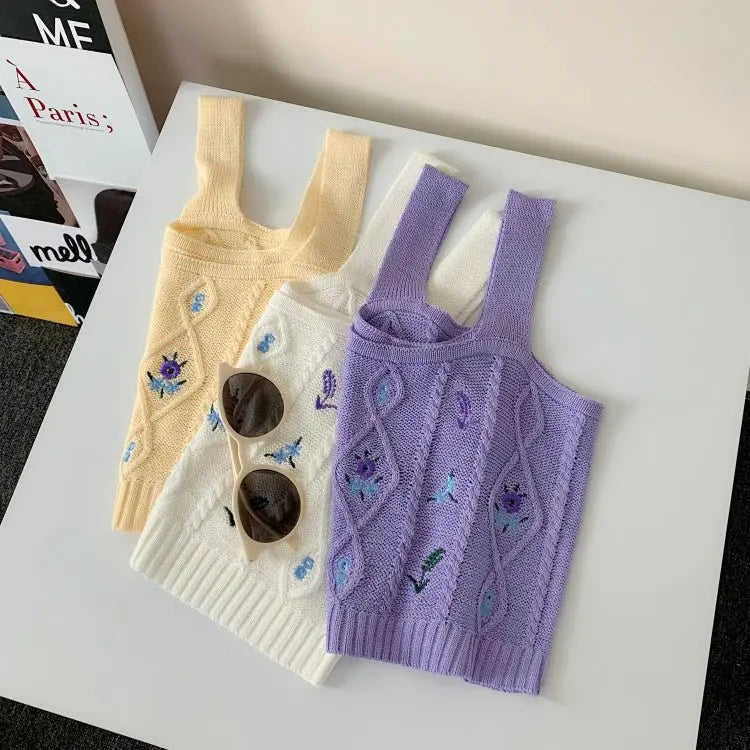 Three Hyuna style knitted crop tops in apricot, white, and purple with floral embroidery and wide shoulder straps