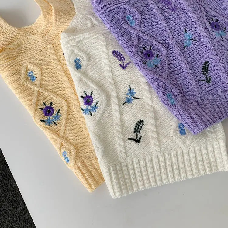 Three Hyuna style crop tops in apricot, white, and purple with floral embroidery and textured knit design