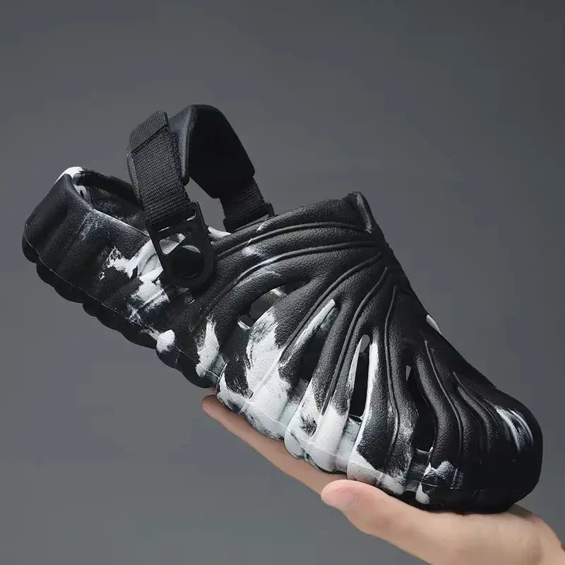 Handheld black and white platform slide sandal with sculpted ridged design and adjustable back strap for men and women