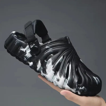 Handheld black and white platform slide sandal with sculpted ridged design and adjustable back strap for men and women