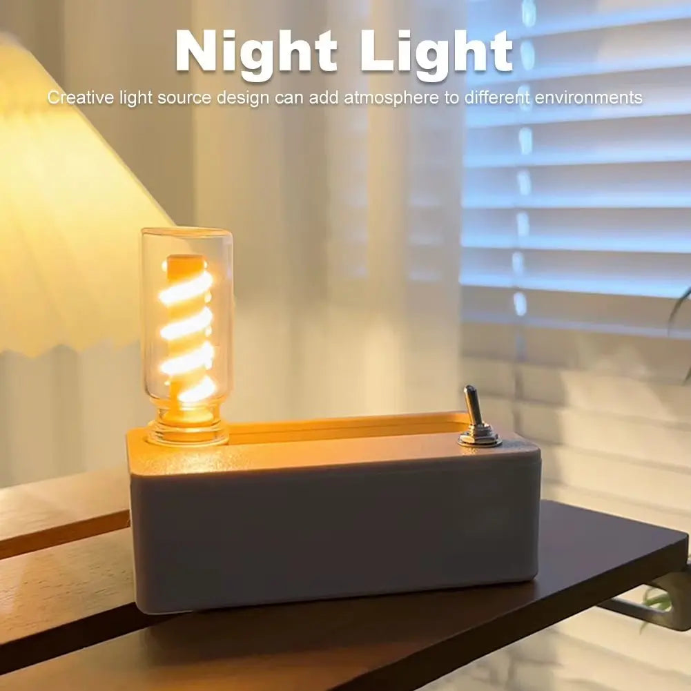 Manual mechanical flip flexible night light with glowing spiral bulb and switch on wooden table by window blinds