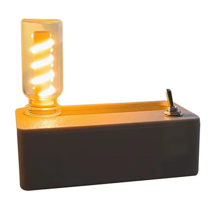 Mechanical flip night light with spiral bulb and toggle switch on rectangular base emitting warm ambient glow