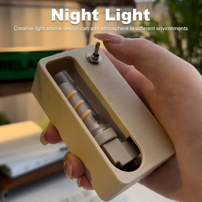 Hand holding beige mechanical flip night light with toggle switch and visible coil inside compact casing