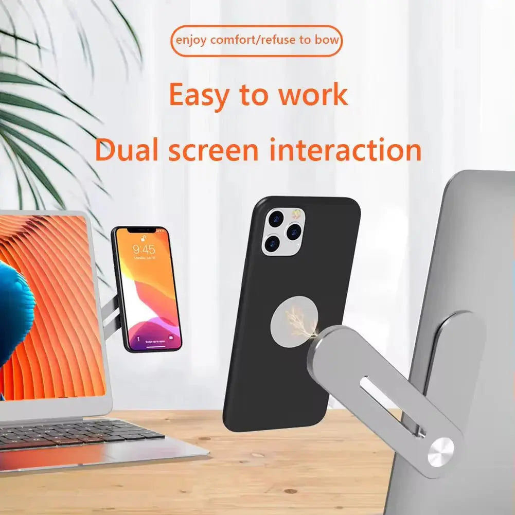 Metal magnetic phone stand attached to laptop for dual screen interaction and hands-free device use on wooden desk