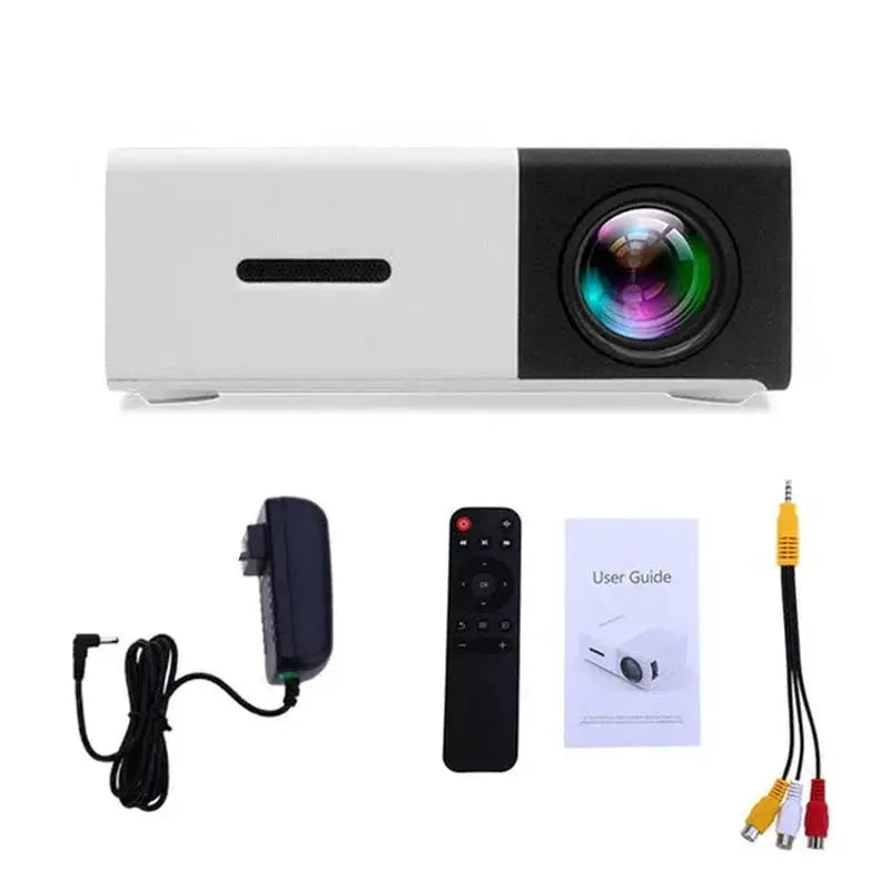 Front view of white and black mini portable LED projector with lens and included remote, power adapter, user guide, and AV cable