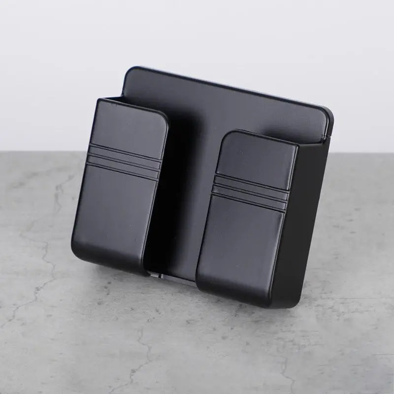 Black mobile phone charging storage rack with punch-free sticky backing and dual compartment design