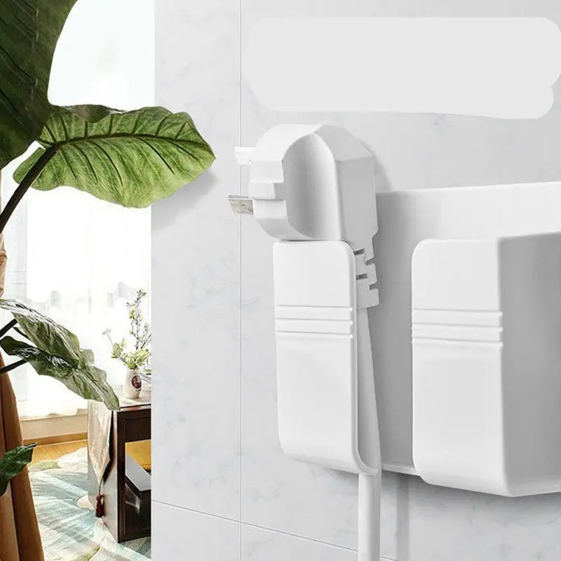 White punch-free sticky mobile phone charging storage box mounted on a marble wall with cable organizer slots