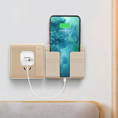 Beige punch-free sticky mobile phone charging storage rack mounted on wall holding phone while charging